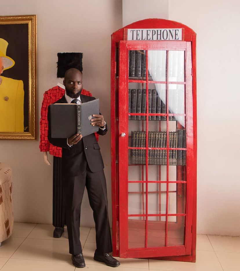 Ibrahim Gbadamosi standing in front of his phonebooth artwork