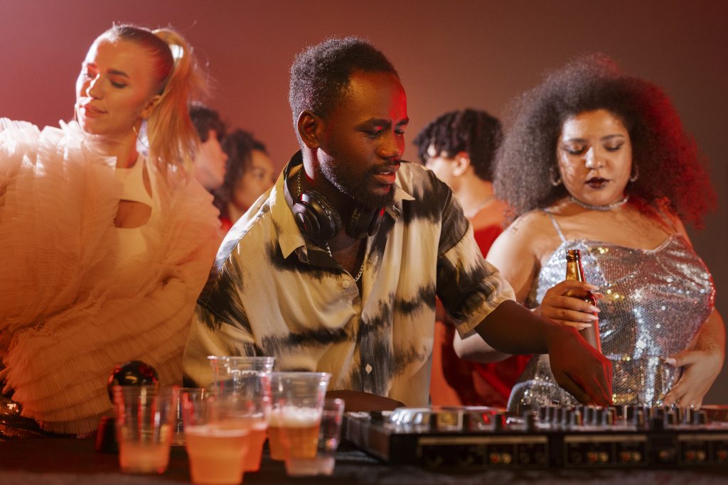 dj surrounded by party goers